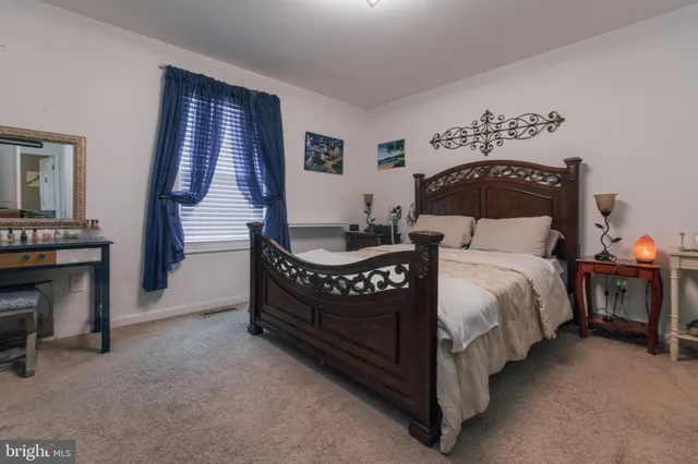 a bedroom with a bed and a television