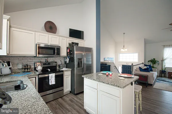 a kitchen with a sink stove and microwave