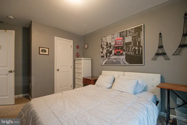 a bedroom with a bed and a large mirror