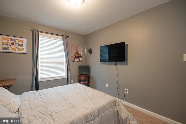 a bedroom with a bed lamp and a closet