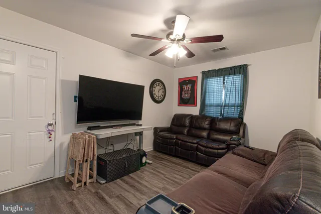a white toilet sitting next to a white sink and a shower curtain
