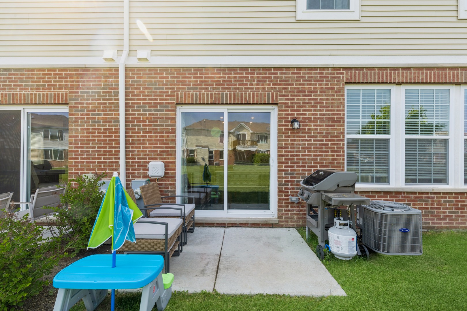 1226 Draper Road McHenry, IL 60050 - Photo 12 of 12 a view of a patio with table and chairs potted plants and floor to ceiling window