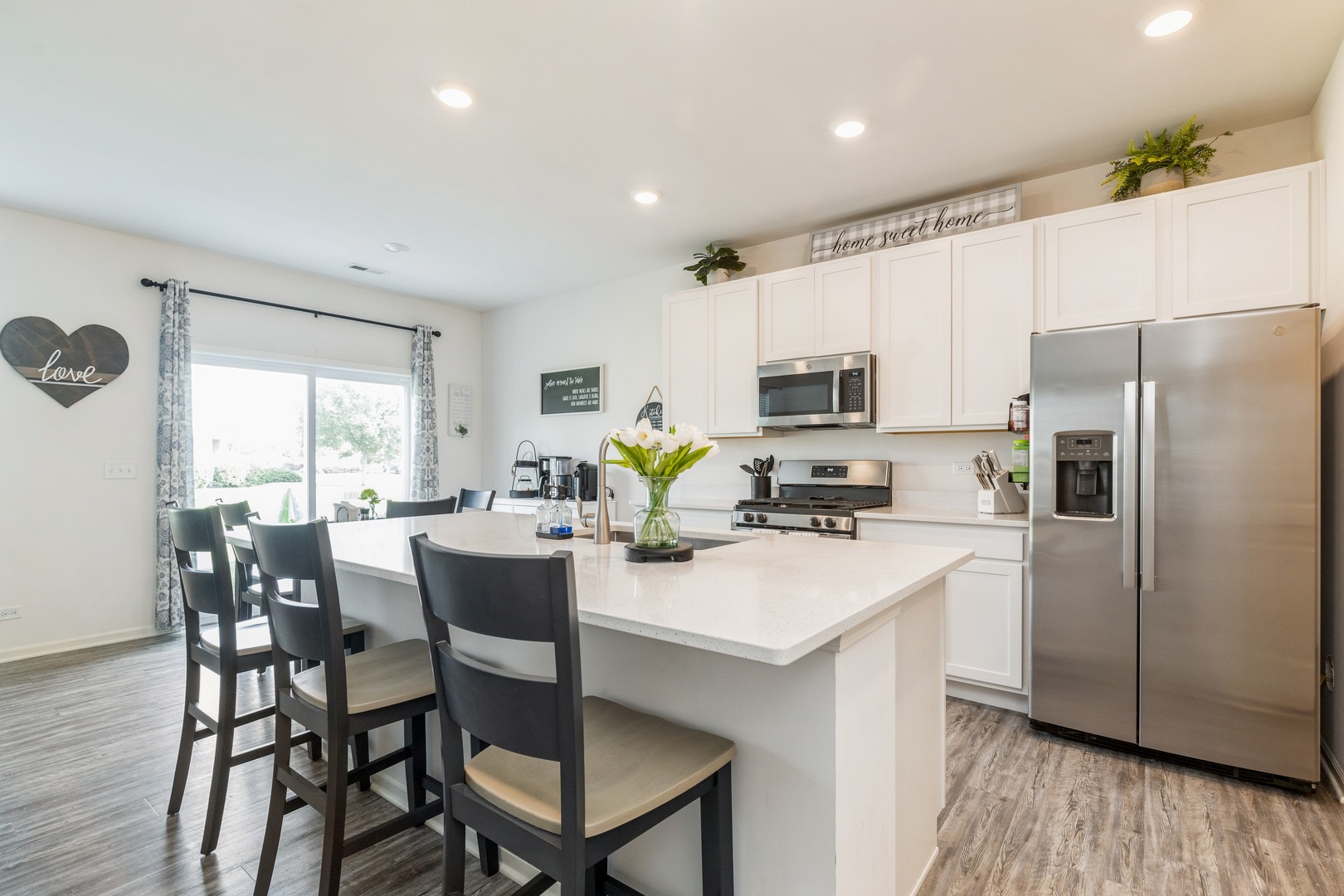 1226 Draper Road McHenry, IL 60050 - Photo 4 of 12 a kitchen with refrigerator cabinets dining table and chairs
