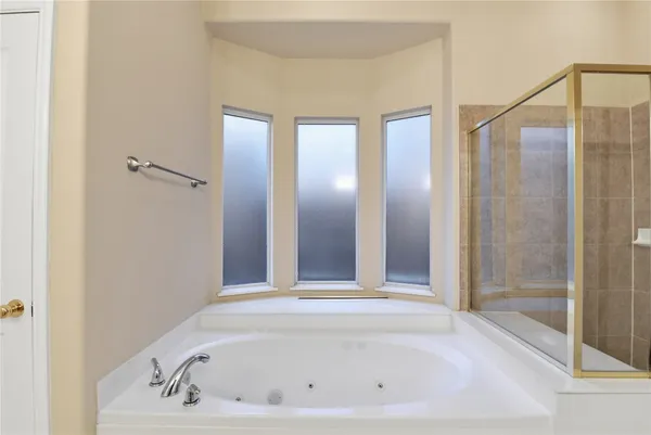 a bathroom with a bathtub and a shower