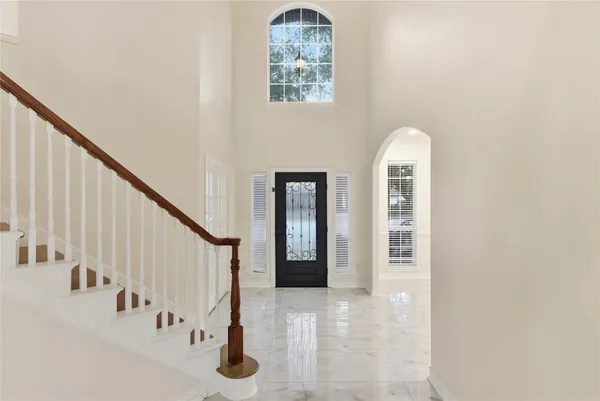 a view of entryway with hallway and stairs