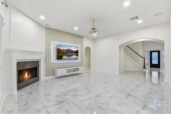 a view of an empty room with a fireplace and a fireplace