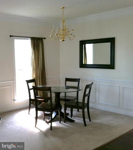 4279 Meyers Road Triangle, VA 22172 - Photo 18 of 24 a view of a dining room with furniture and chandelier