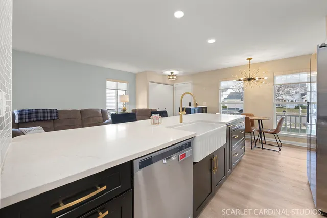 a large white kitchen with a large counter top furniture and appliances