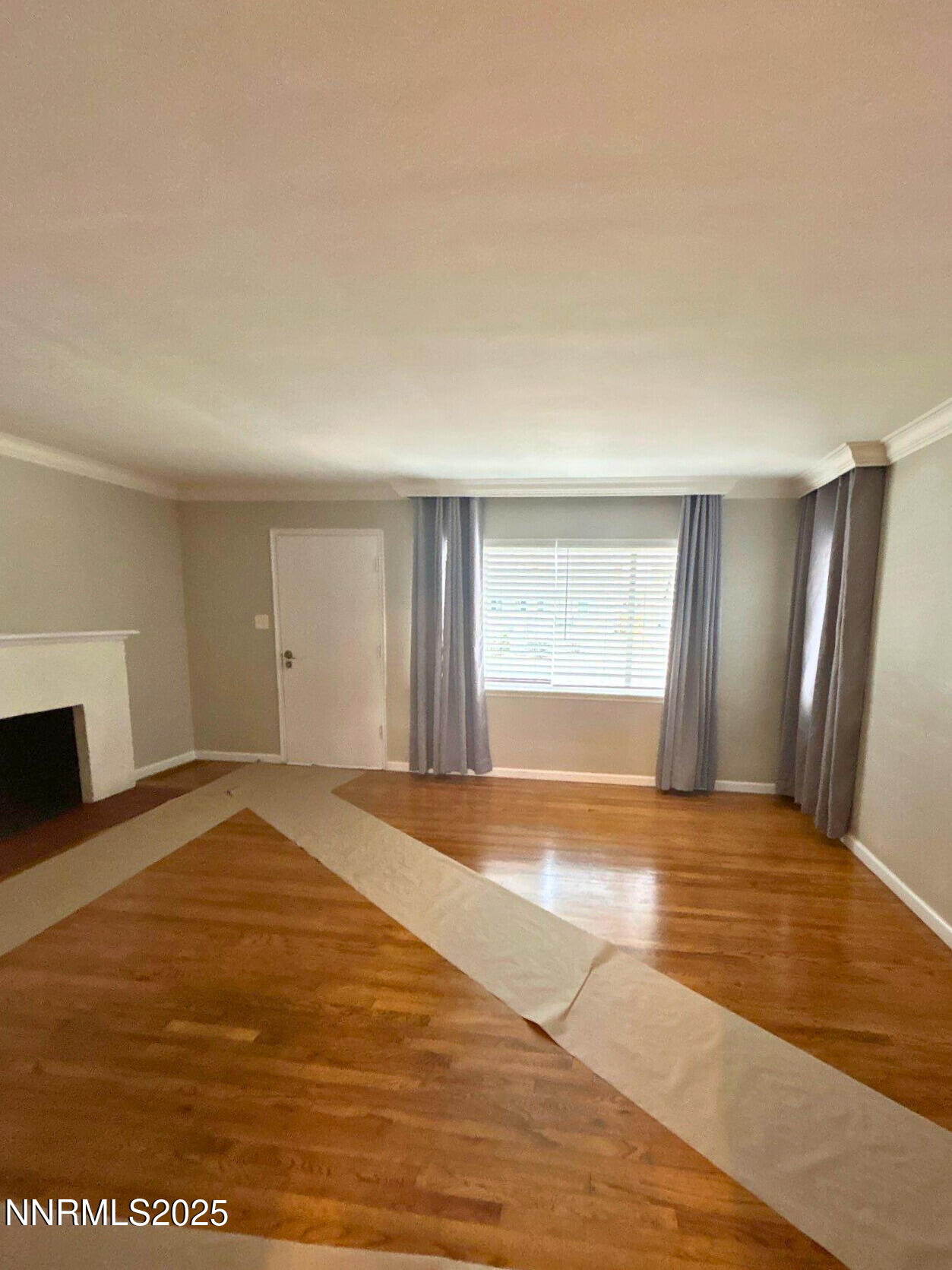 320 West Plumb Lane Reno, NV 89509 - Photo 3 of 22 a view of an empty room with window and wooden floor