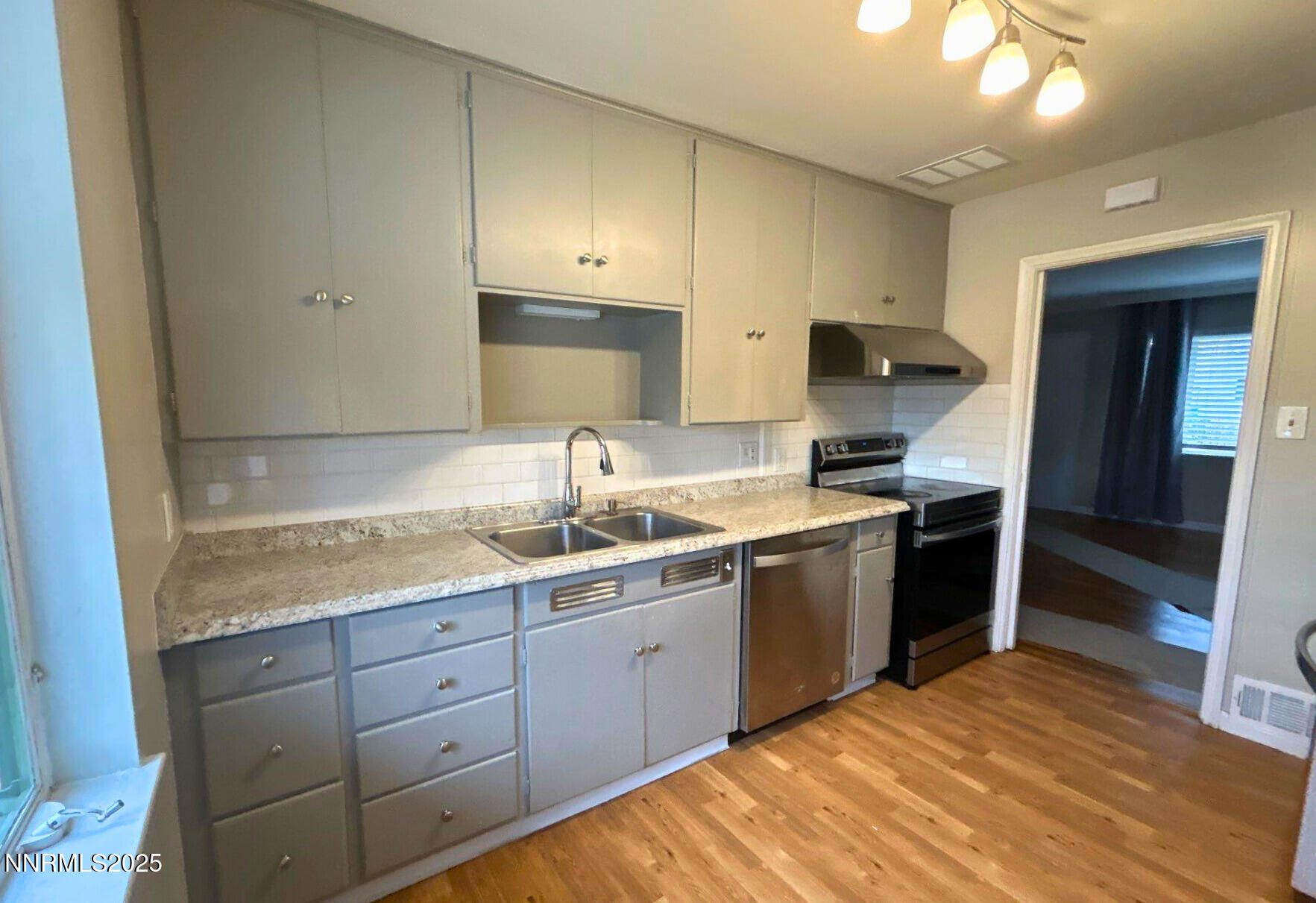 320 West Plumb Lane Reno, NV 89509 - Photo 5 of 22 a kitchen with a sink stove and cabinets