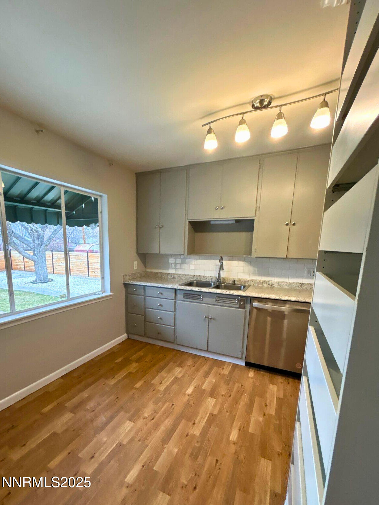 320 West Plumb Lane Reno, NV 89509 - Photo 7 of 22 a kitchen with kitchen island granite countertop a sink cabinets and stainless steel appliances