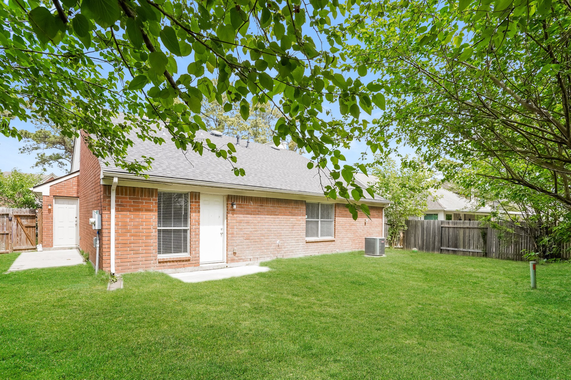 1635 Ridgebriar Drive Houston, TX 77014 - Photo 19 of 21 a front view of a house with a garden and yard