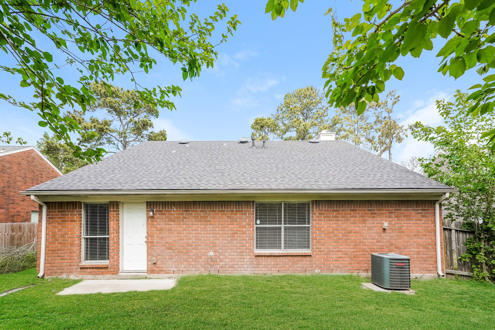 1635 Ridgebriar Drive Houston, TX 77014 - Photo 20 of 21 a view of a brick house with a yard potted plants and a large tree