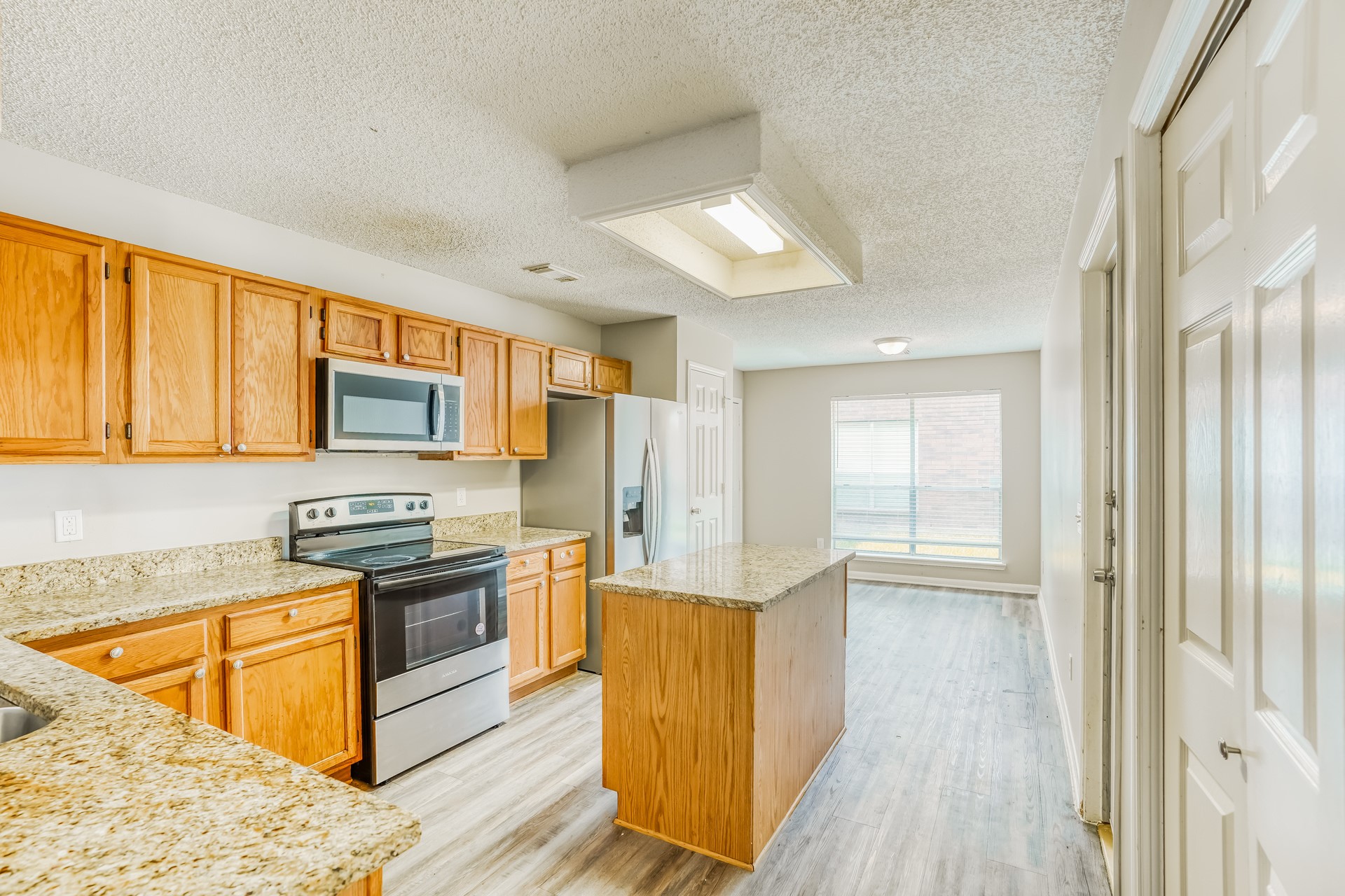 1635 Ridgebriar Drive Houston, TX 77014 - Photo 9 of 21 a kitchen with stainless steel appliances granite countertop a stove top oven a sink dishwasher a refrigerator and cabinets with wooden floor
