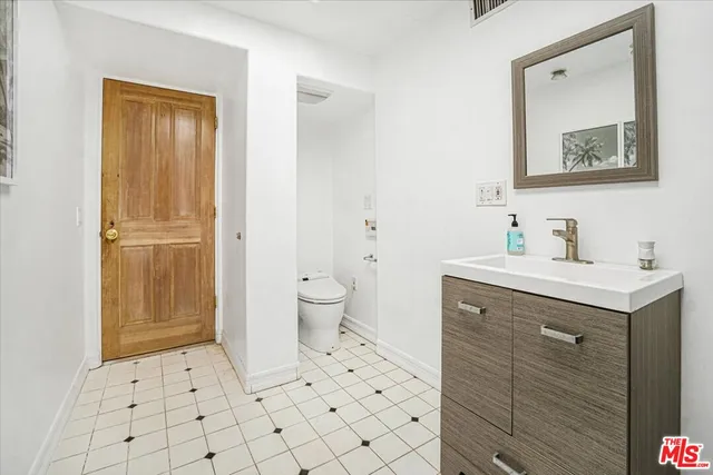 a spacious bathroom with a sink mirror and vanity