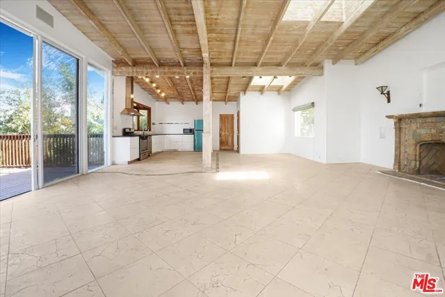 a view of an empty room with a fireplace