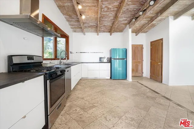 a view of a kitchen with a sink cabinets and a window