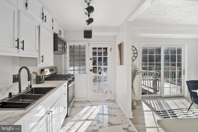 a kitchen with stainless steel appliances a sink a stove and a refrigerator