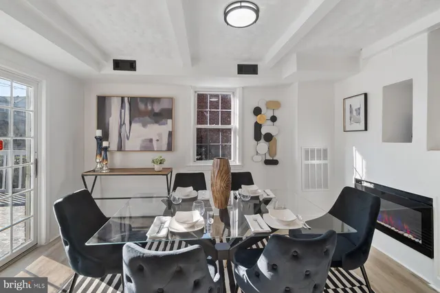 a dining room with furniture and wooden floor