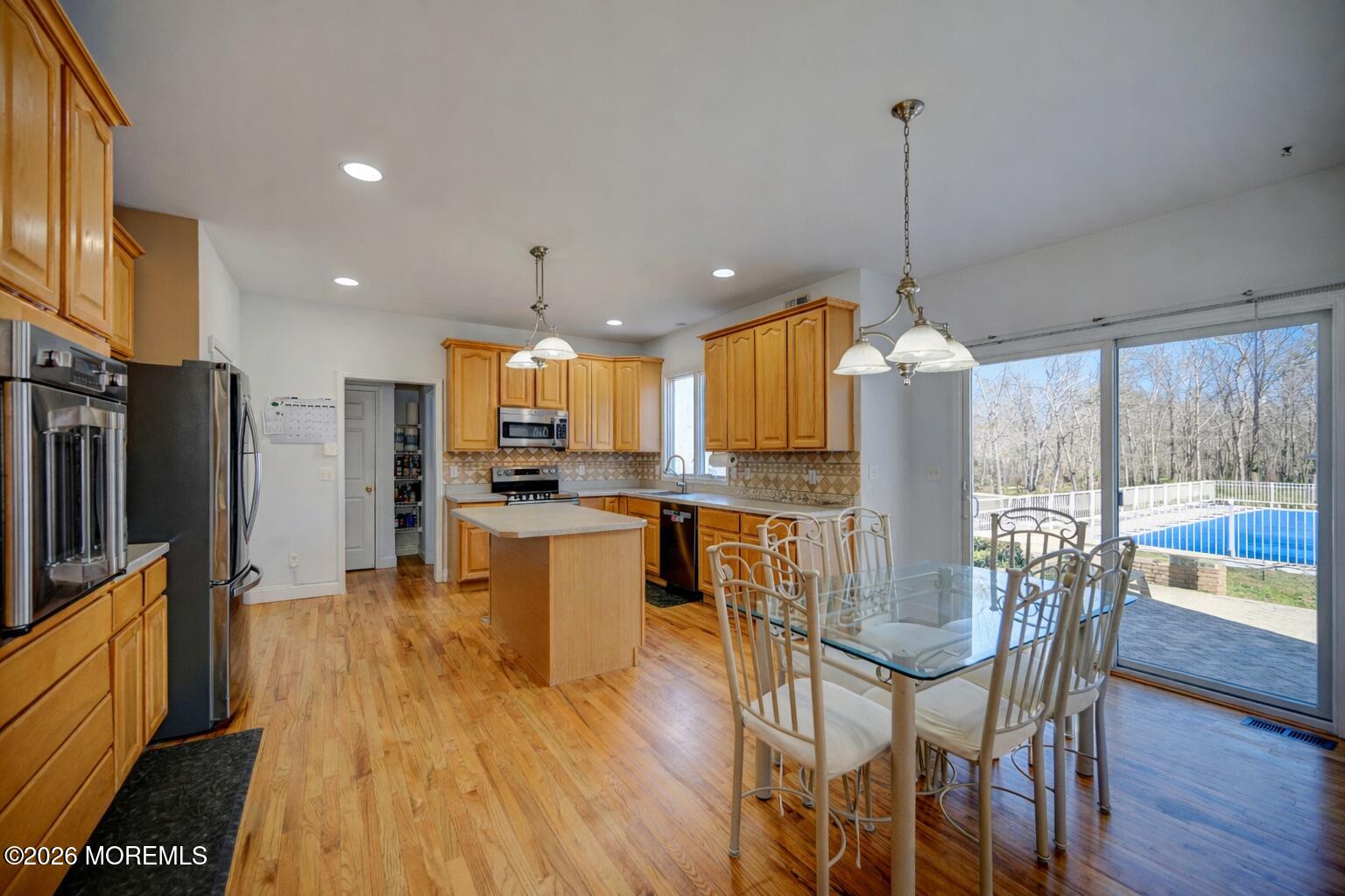 435 Vath Street Jackson, NJ 08527 - Photo 12 of 59 a view of a dining room and livingroom with furniture wooden floor a chandelier