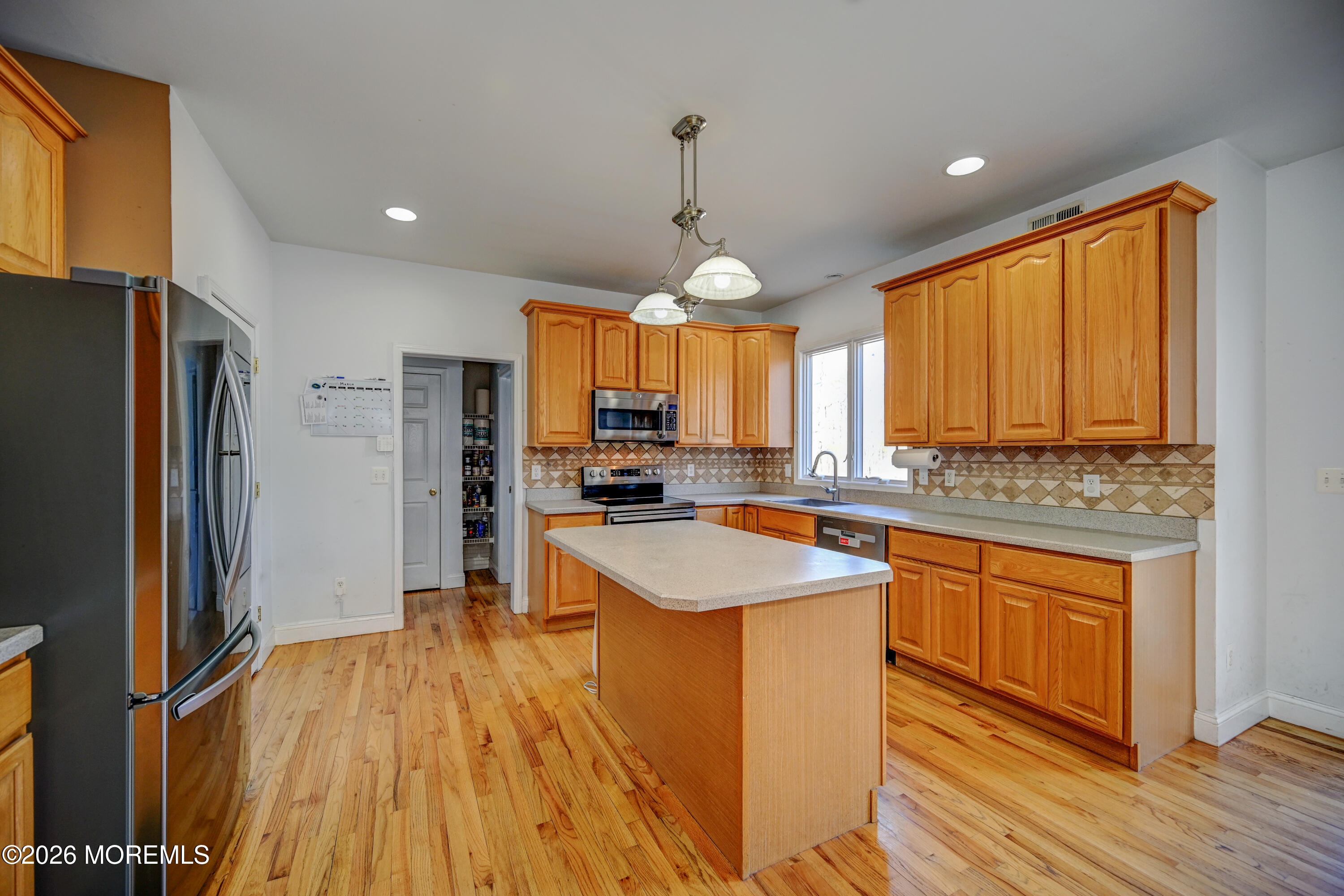 435 Vath Street Jackson, NJ 08527 - Photo 13 of 59 a kitchen with stainless steel appliances granite countertop a sink stove and refrigerator