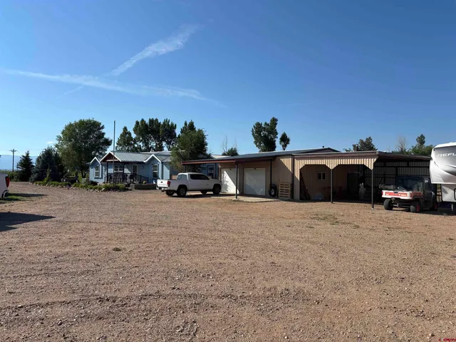 a kitchen with kitchen island granite countertop a sink cabinets and stainless steel appliances
