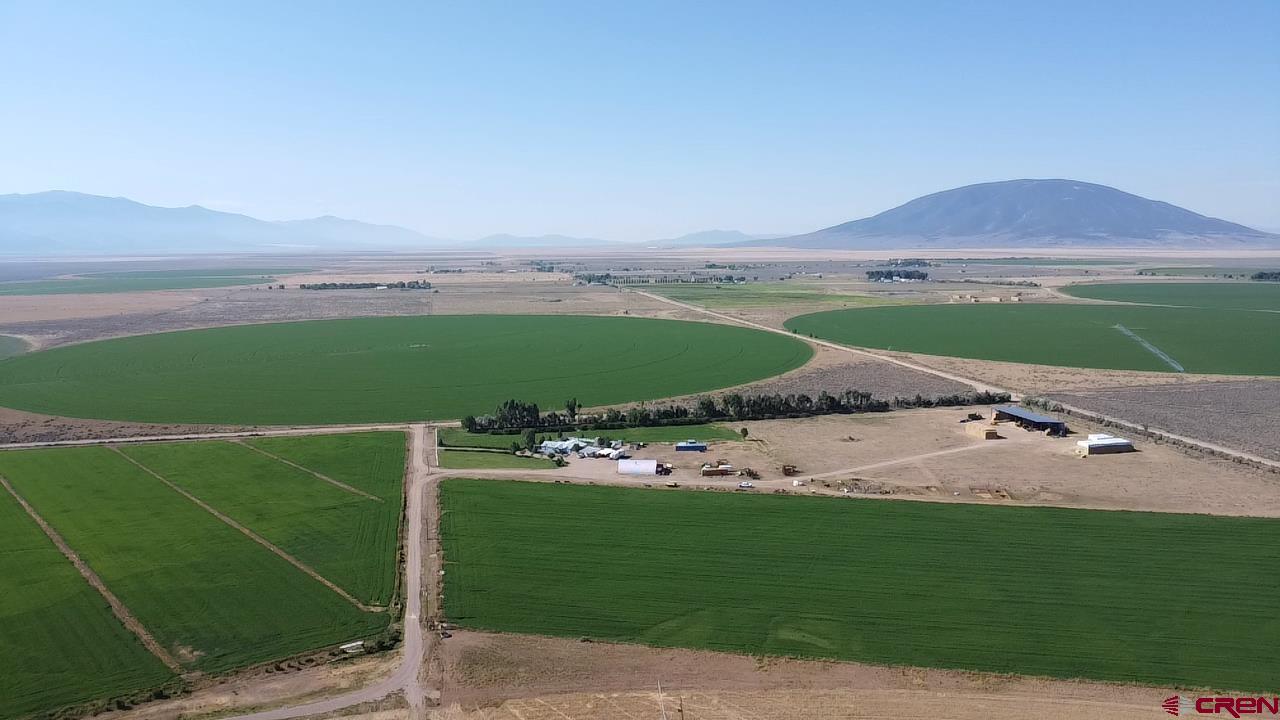 9227 County Rd C Jaroso, CO 81138 - Photo 2 of 28 a aerial view of a house with a garden and trees