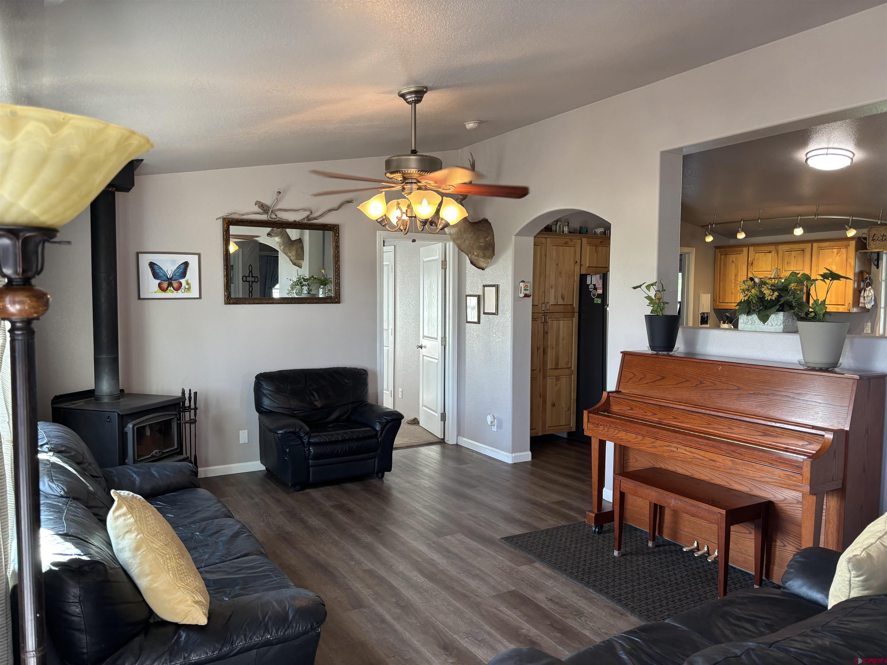 9227 County Rd C Jaroso, CO 81138 - Photo 21 of 28 a living room with furniture and a chandelier