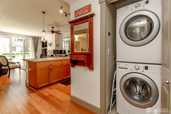 a view of a kitchen with refrigerator and wooden floor