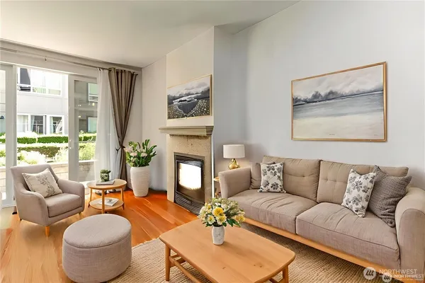 a living room with furniture a fireplace and a flat screen tv