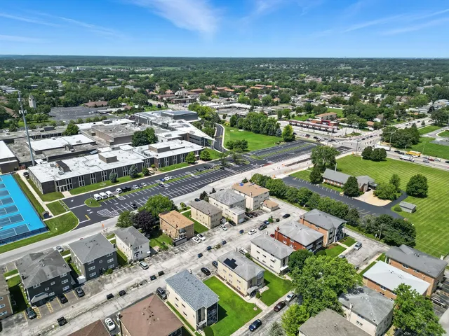 an aerial view of residential houses with outdoor space