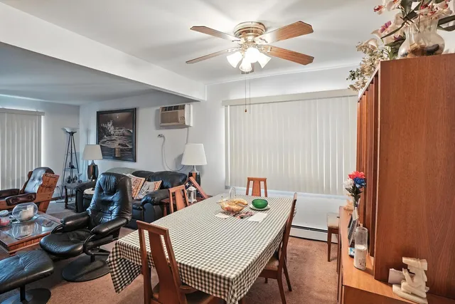 a view of a dining room with furniture and chandelier