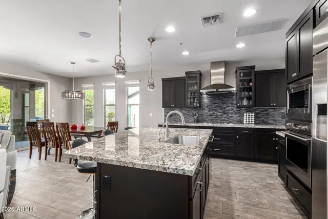 a kitchen with center island and large windows