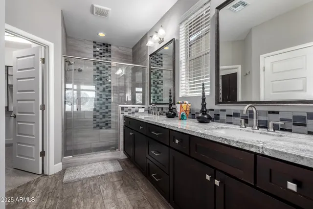 a kitchen with granite countertop kitchen island stainless steel appliances a stove a sink a oven a dining table and chairs