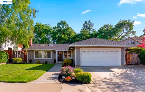 a front view of a house with a yard and a garage