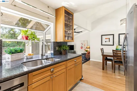 a kitchen with stainless steel appliances granite countertop a sink and cabinets