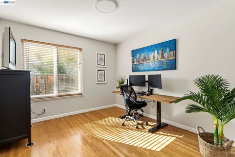 a view of a workspace with furniture and a window