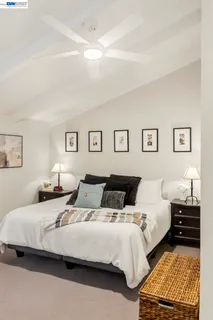 a bedroom with two beds and painting on the wall