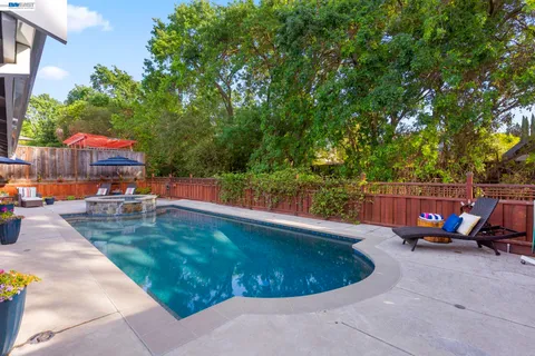 a view of a swimming pool with a lounge chairs