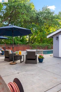 an outdoor sitting area with chairs and table