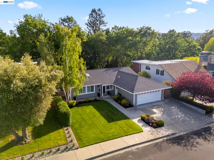 a aerial view of a house with swimming pool and big yard