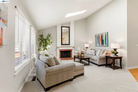 a living room with furniture fireplace and window
