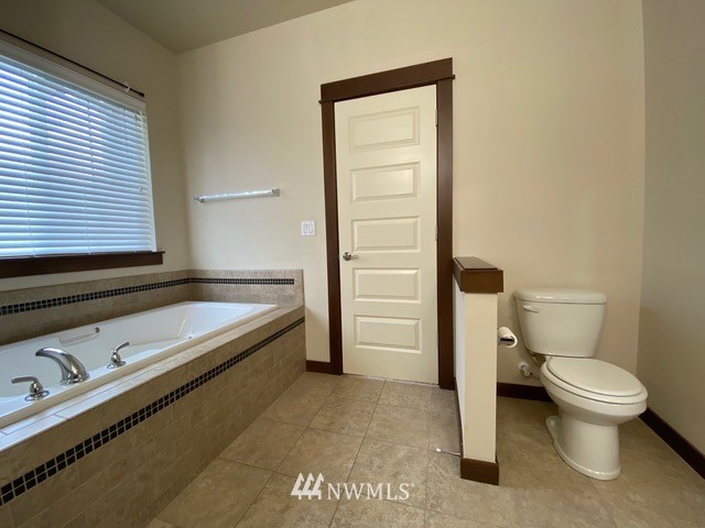 419 203rd Place Southeast Bothell, WA 98012 - Photo 21 of 30 a spacious bathroom with a granite countertop toilet and sink