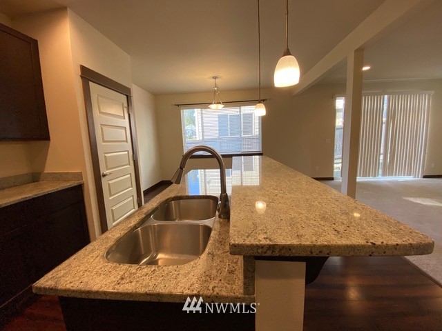 419 203rd Place Southeast Bothell, WA 98012 - Photo 25 of 30 a kitchen with a sink a counter space and a refrigerator