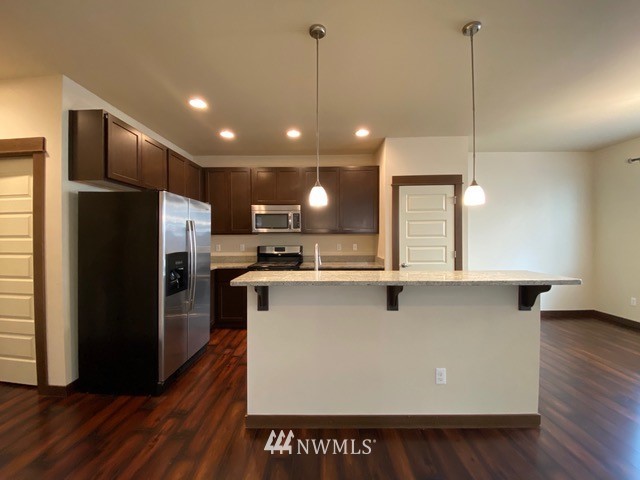 419 203rd Place Southeast Bothell, WA 98012 - Photo 28 of 30 a kitchen with stainless steel appliances a refrigerator a sink and wooden floor