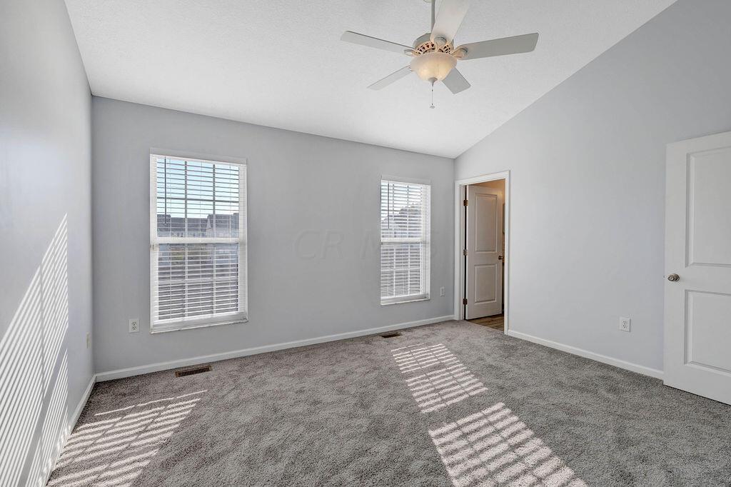 6345 Needletail Road, Unit 24634 Columbus, OH 43230 - Photo 18 of 58 • New gray carpet ~ 2021 • Gray painted walls • Vaulted ceiling • Lighted ceiling fan • 2” blinds
