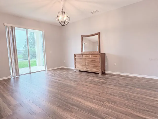 a large kitchen with stainless steel appliances kitchen island granite countertop a sink and cabinets