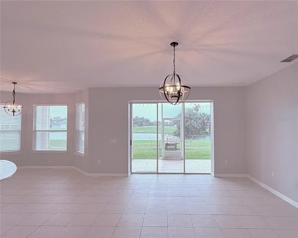 a large white kitchen with a sink a stove and a refrigerator
