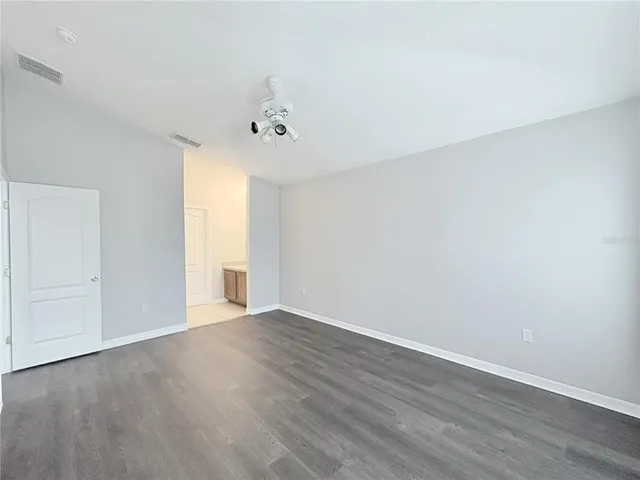 a living room with wooden floor and a window