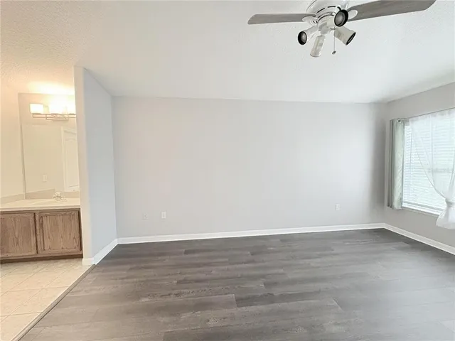 a bedroom with a bed and a chandelier fan